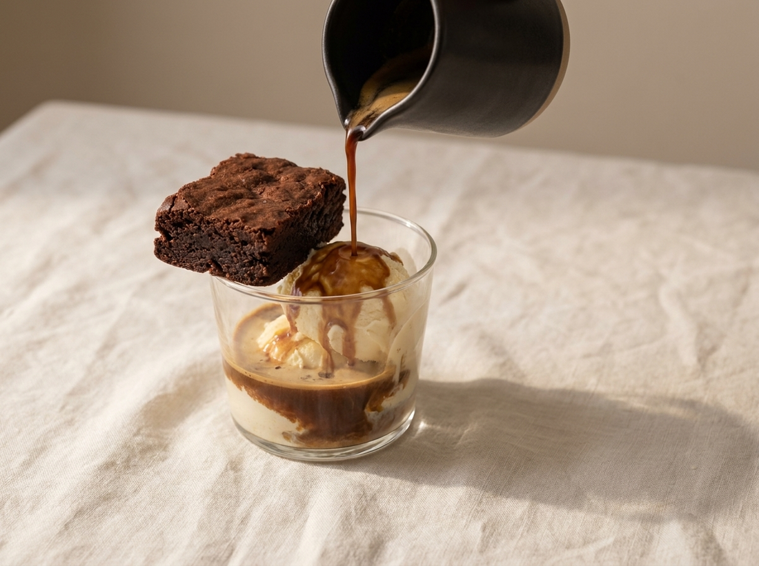 A brownie affogato with espresso poured over ice cream